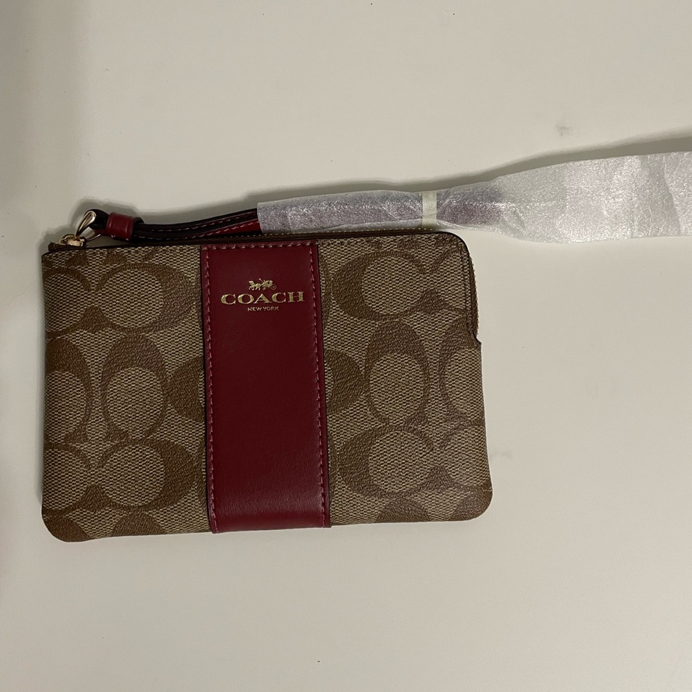 Coach Brown and Red Wristlet
Unused 
With tags
6 inches across 
4 inches down